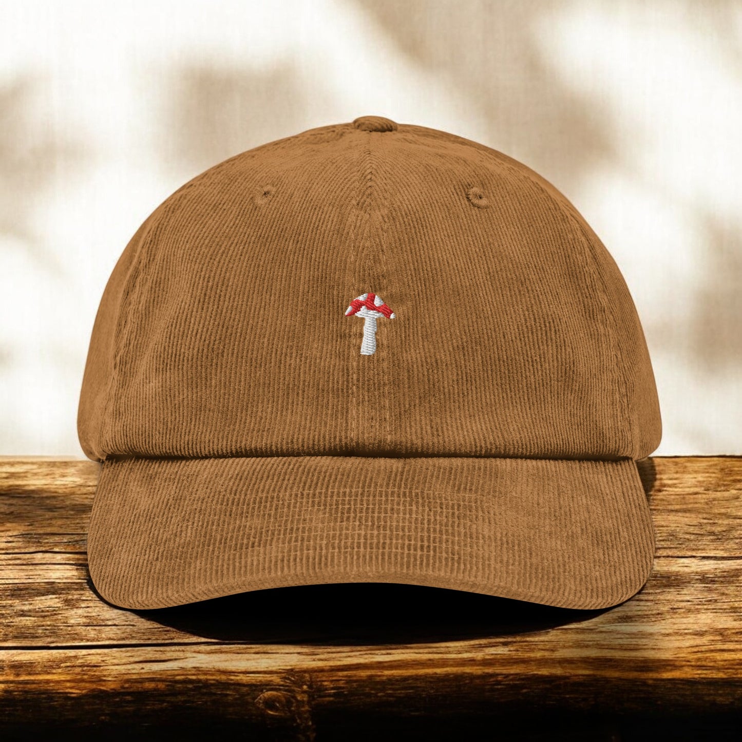 Camel Corduroy Fly Agaric cap on a wooden surface