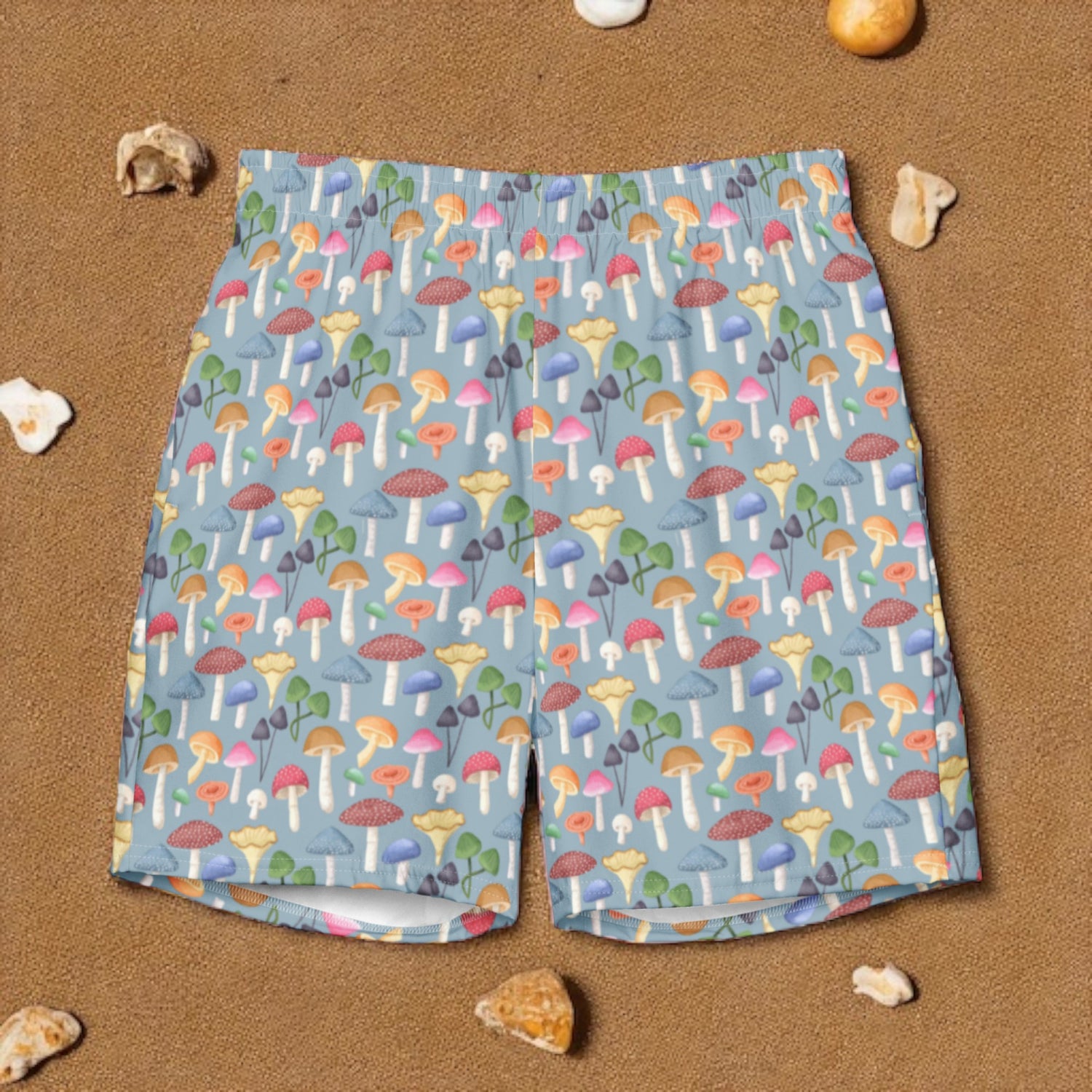 Colorful mushroom-patterned shorts on a sandy background