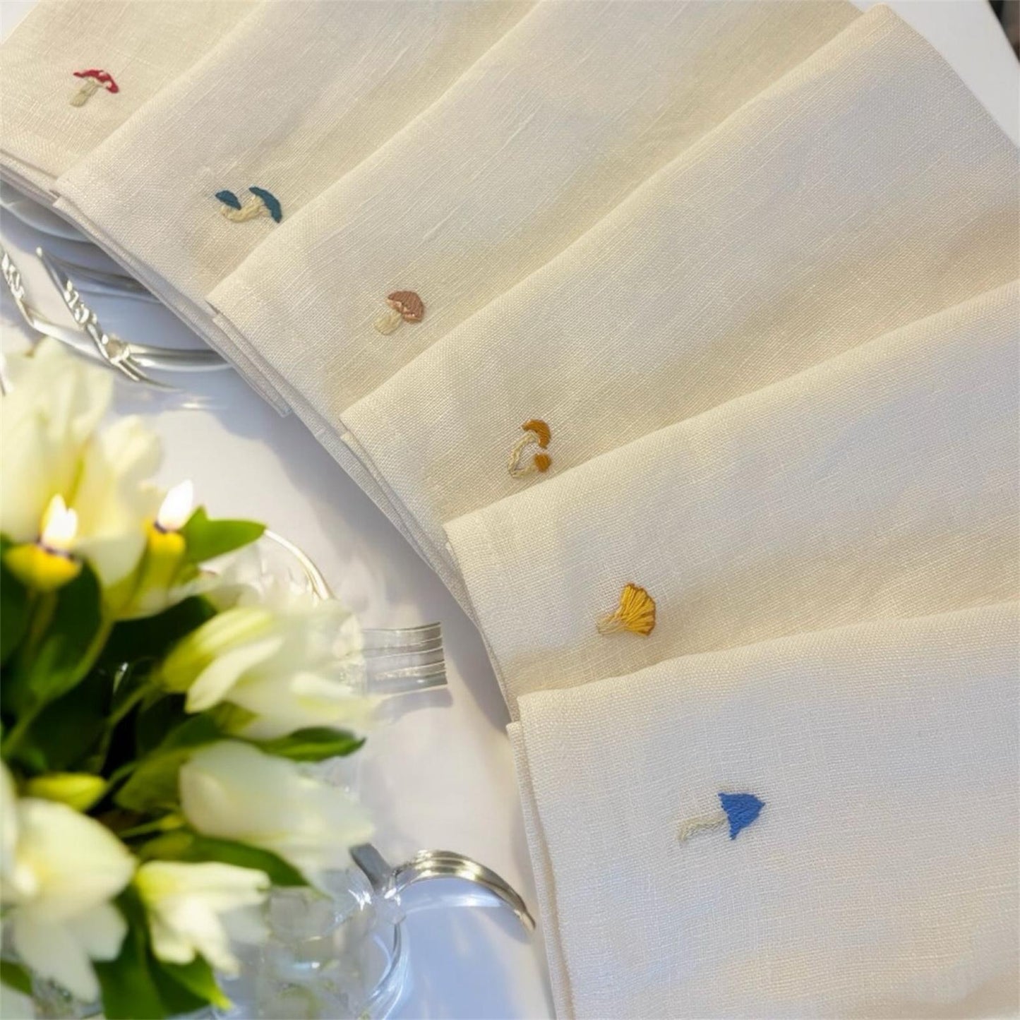 Embroidered Mushroom Napkin Set in a styled table setting with flowers and candles.