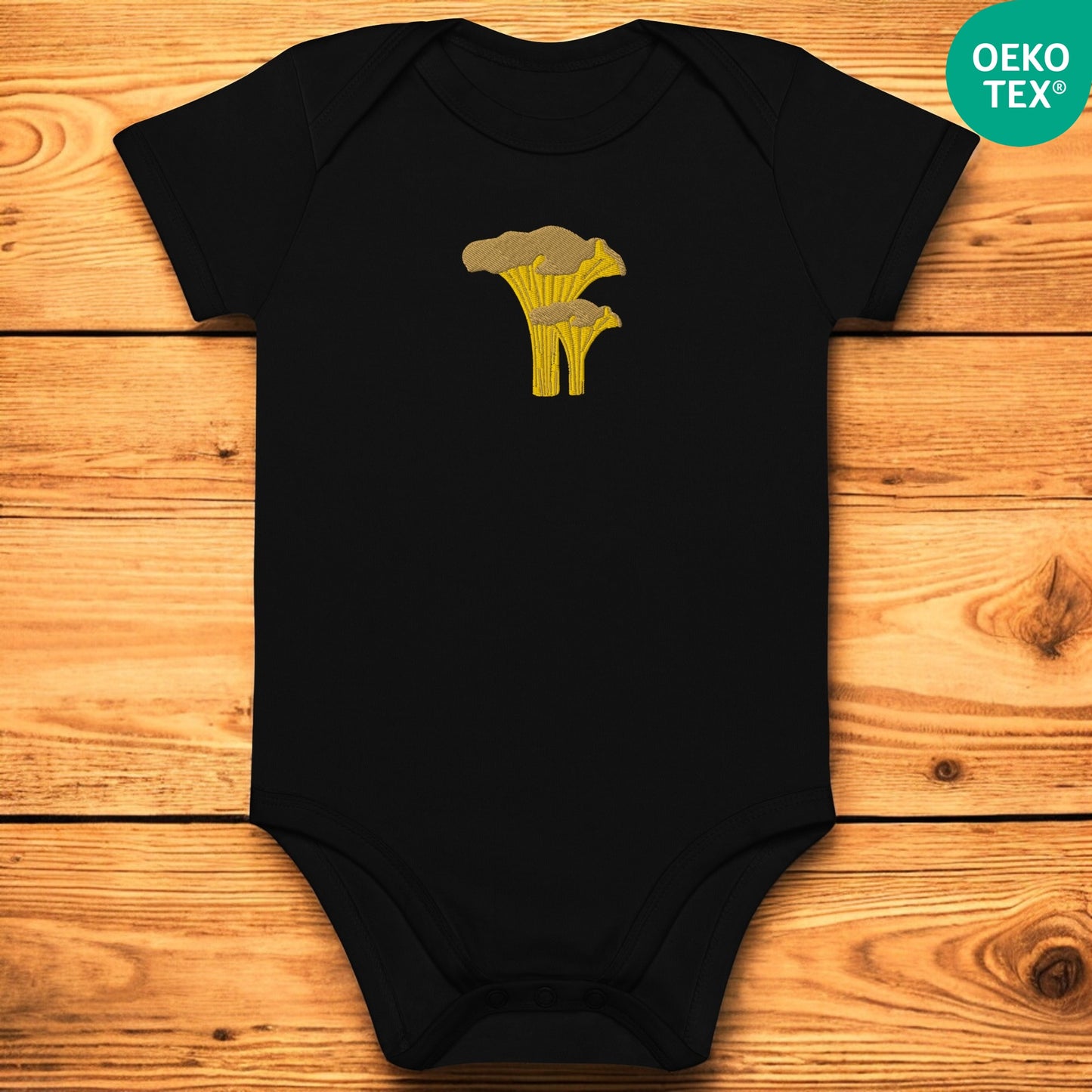 Black baby body with chanterelle on a wooden floor