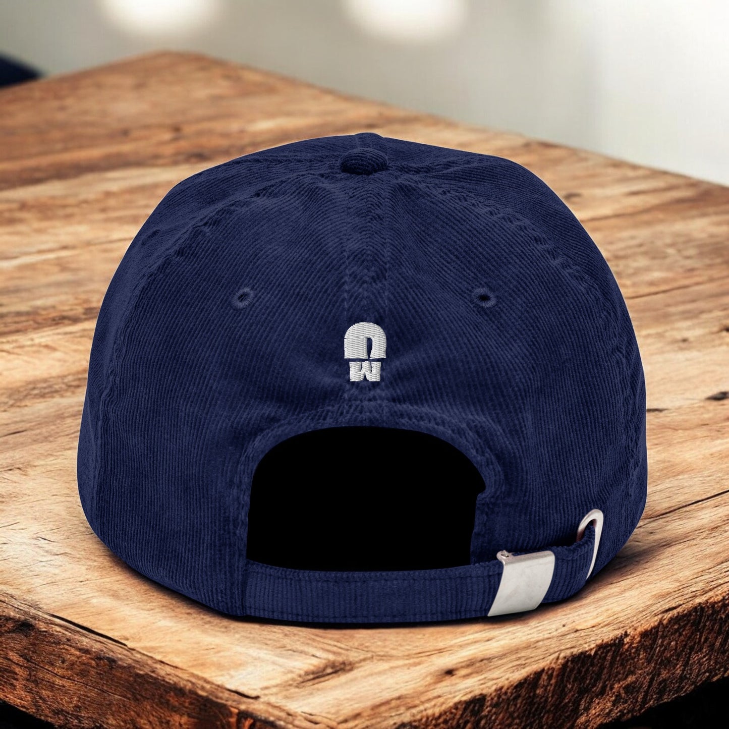 Blue Corduroy Paris Mushroom cap from the back on a wooden surface
