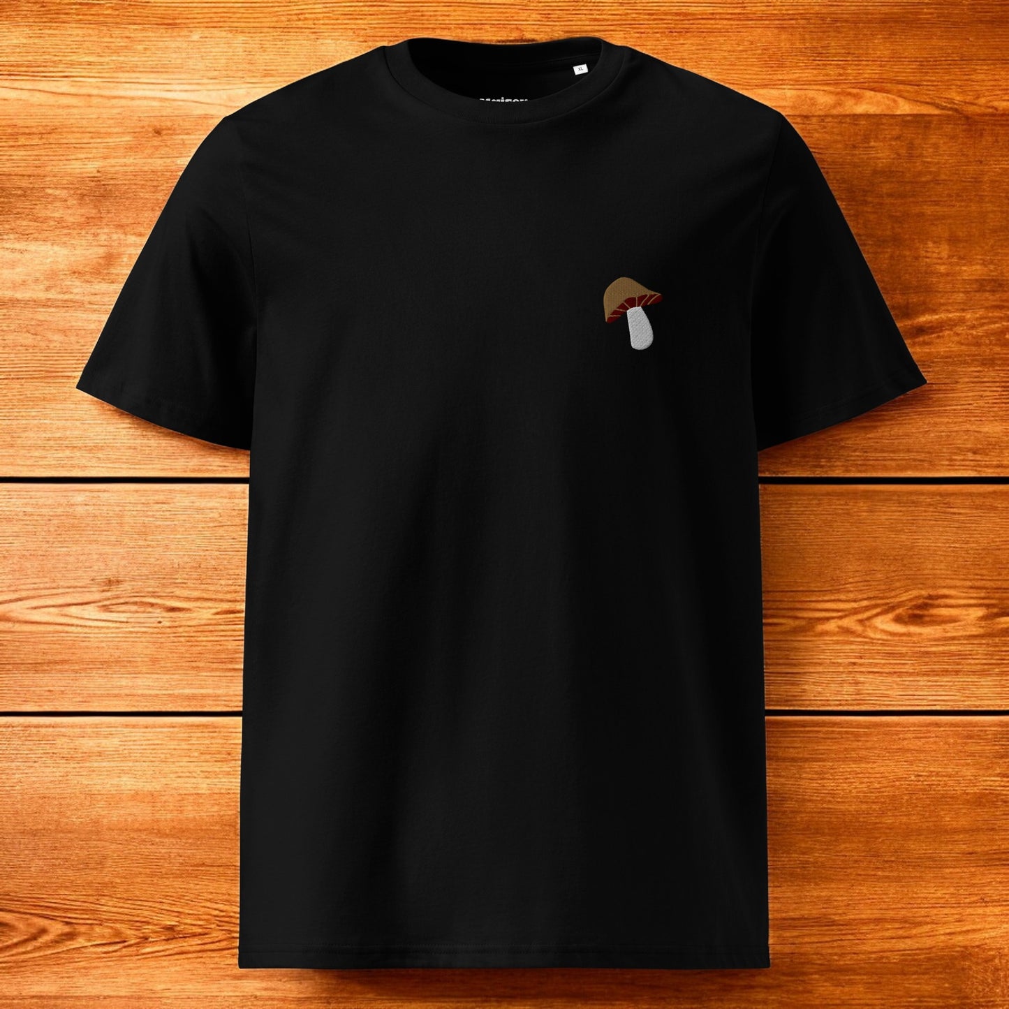 black t-shirt with a porcini mushroom and a wood background