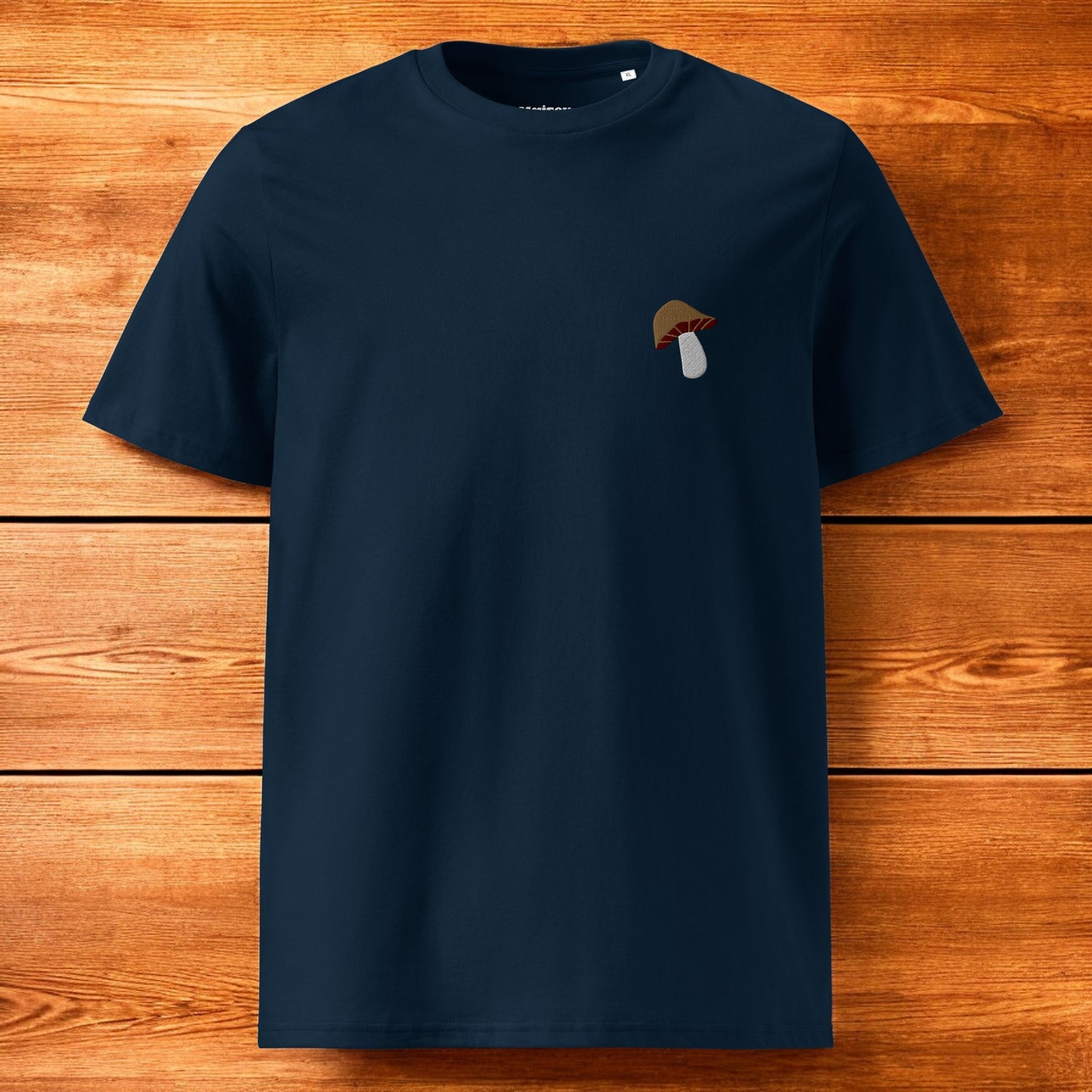 navy blue t-shirt with a porcini mushroom and a wood background