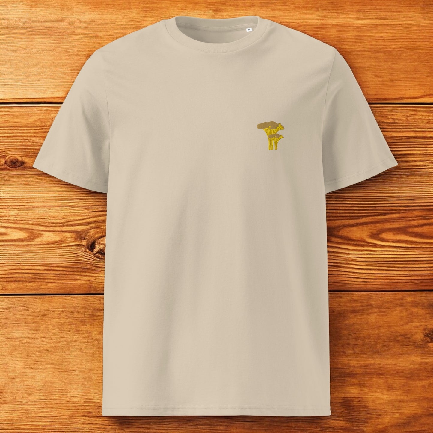beige t-shirt with chanterelle and a wood background