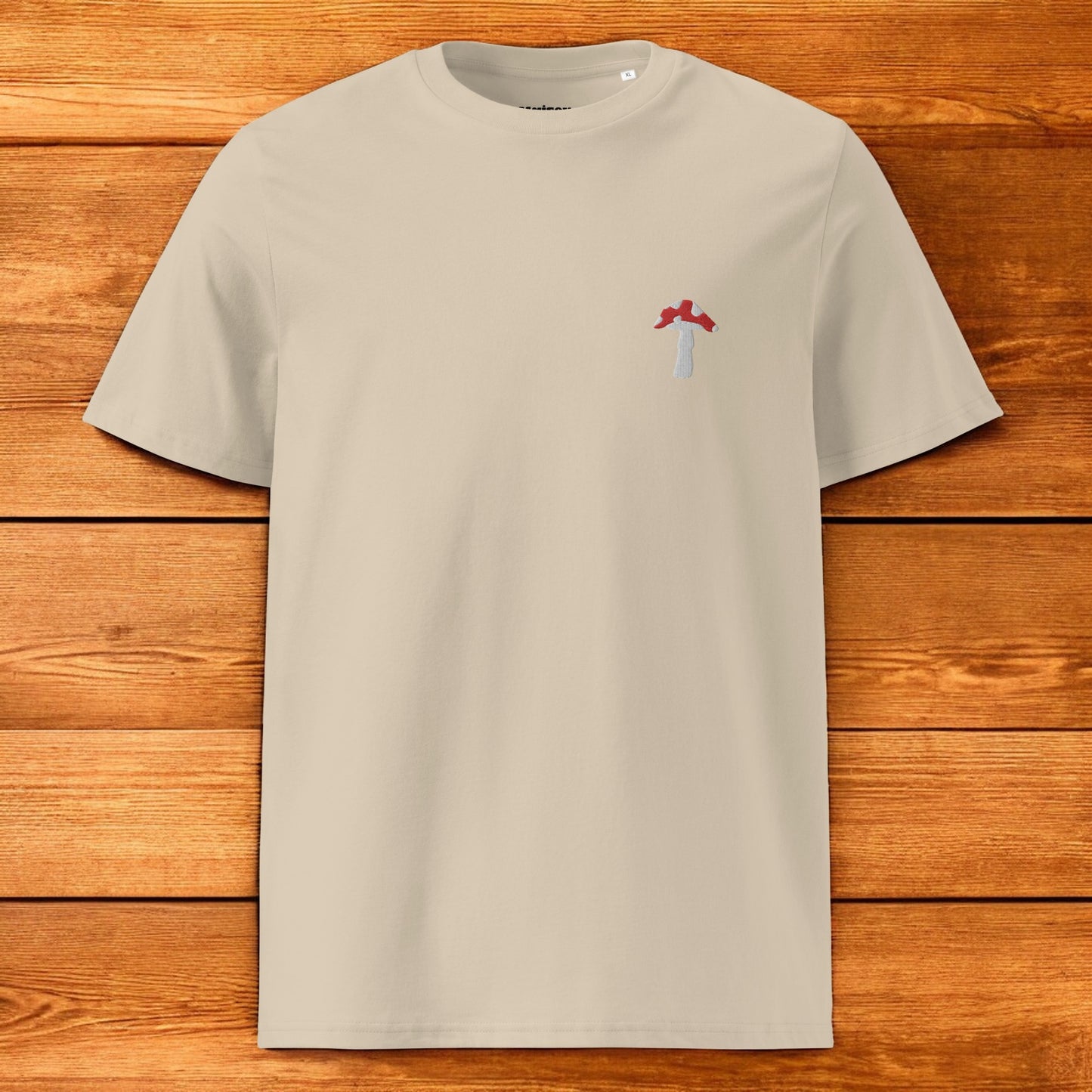 beige t-shirt with fly agaric and a wood background