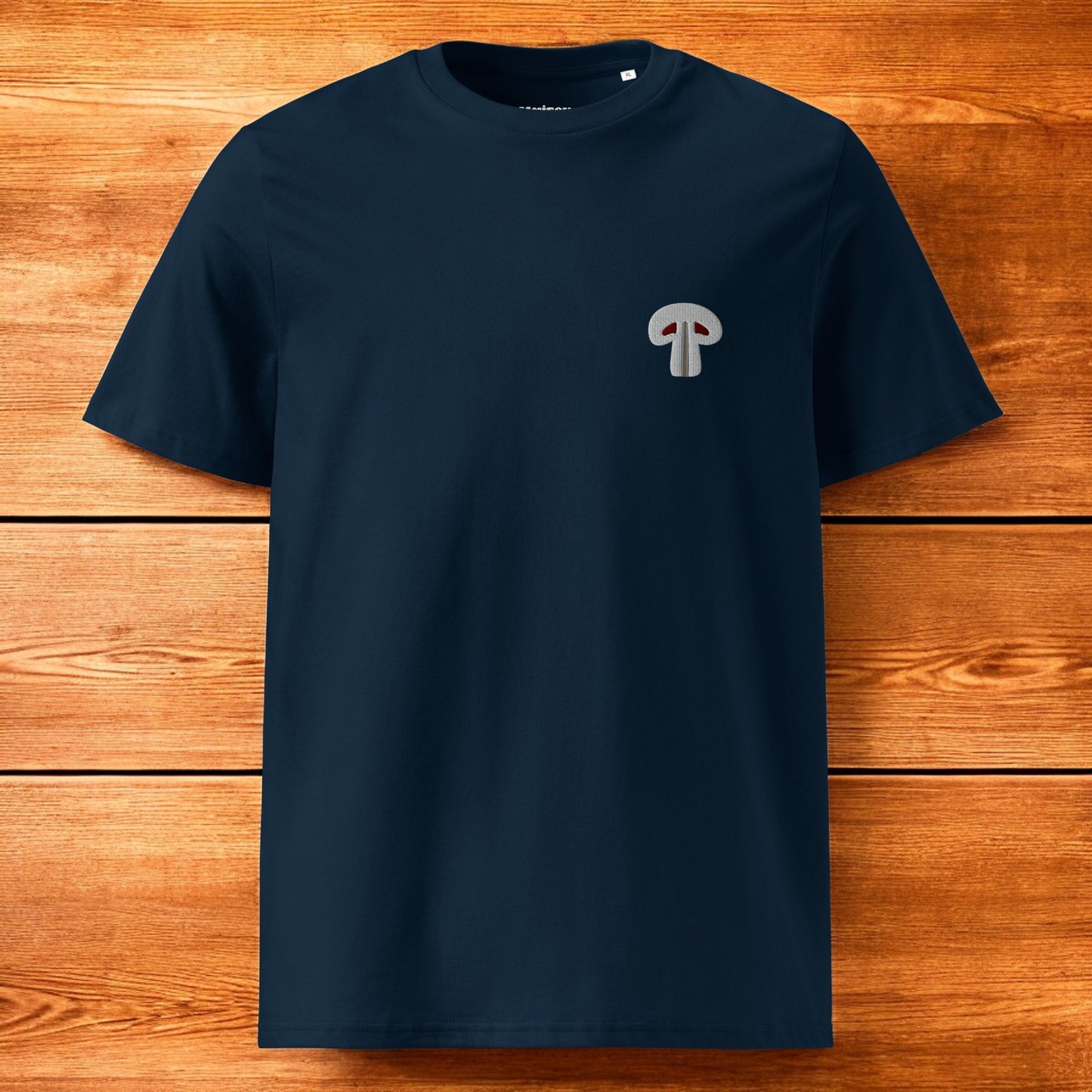 blue t-shirt with paris mushroom and a wood background