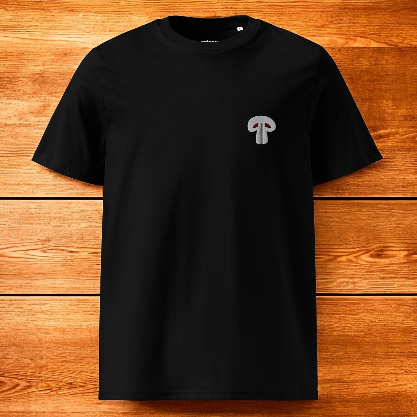 black t-shirt with paris mushroom and a wood background