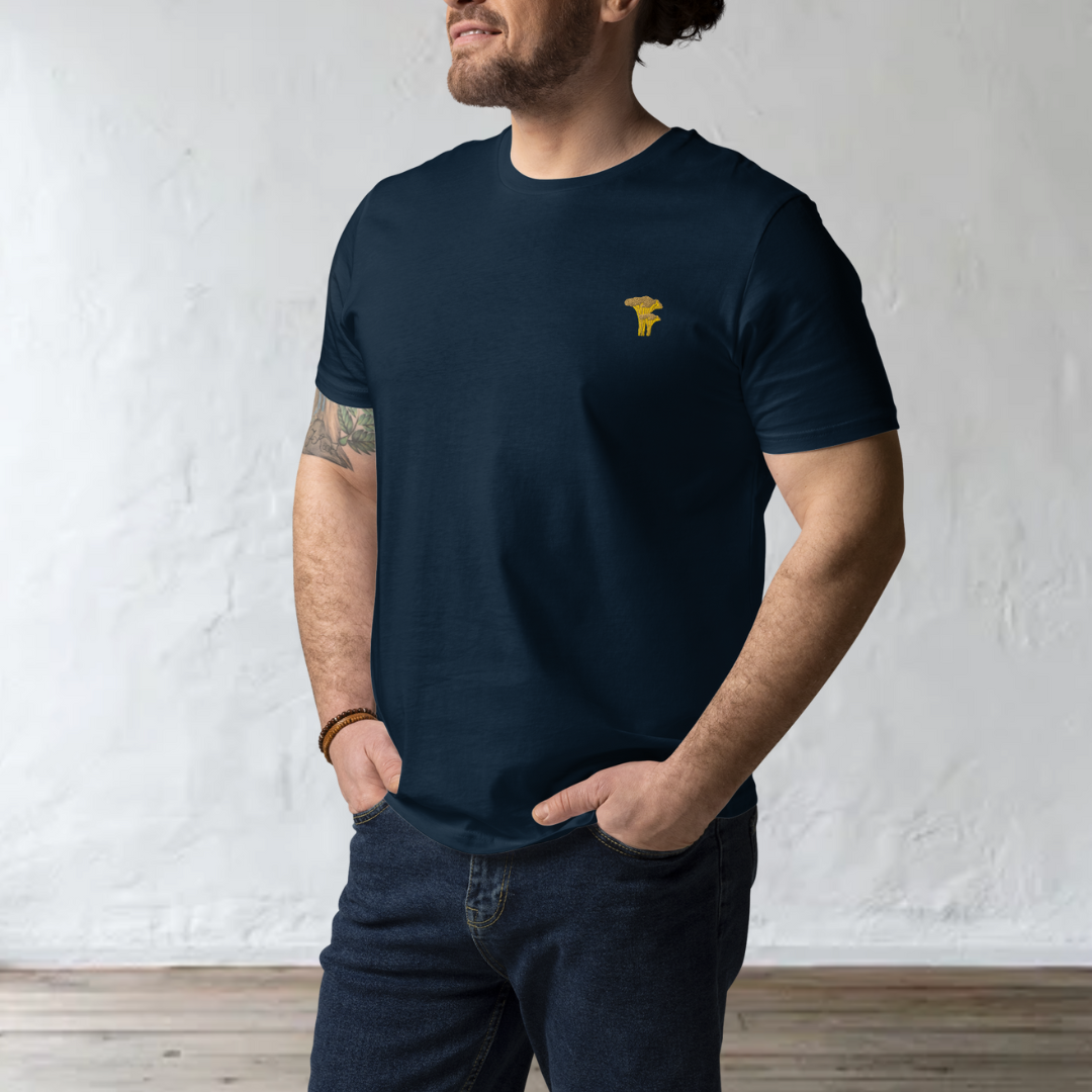 man model wearting navy blue t-shirt with a chanterelle and a wood background
