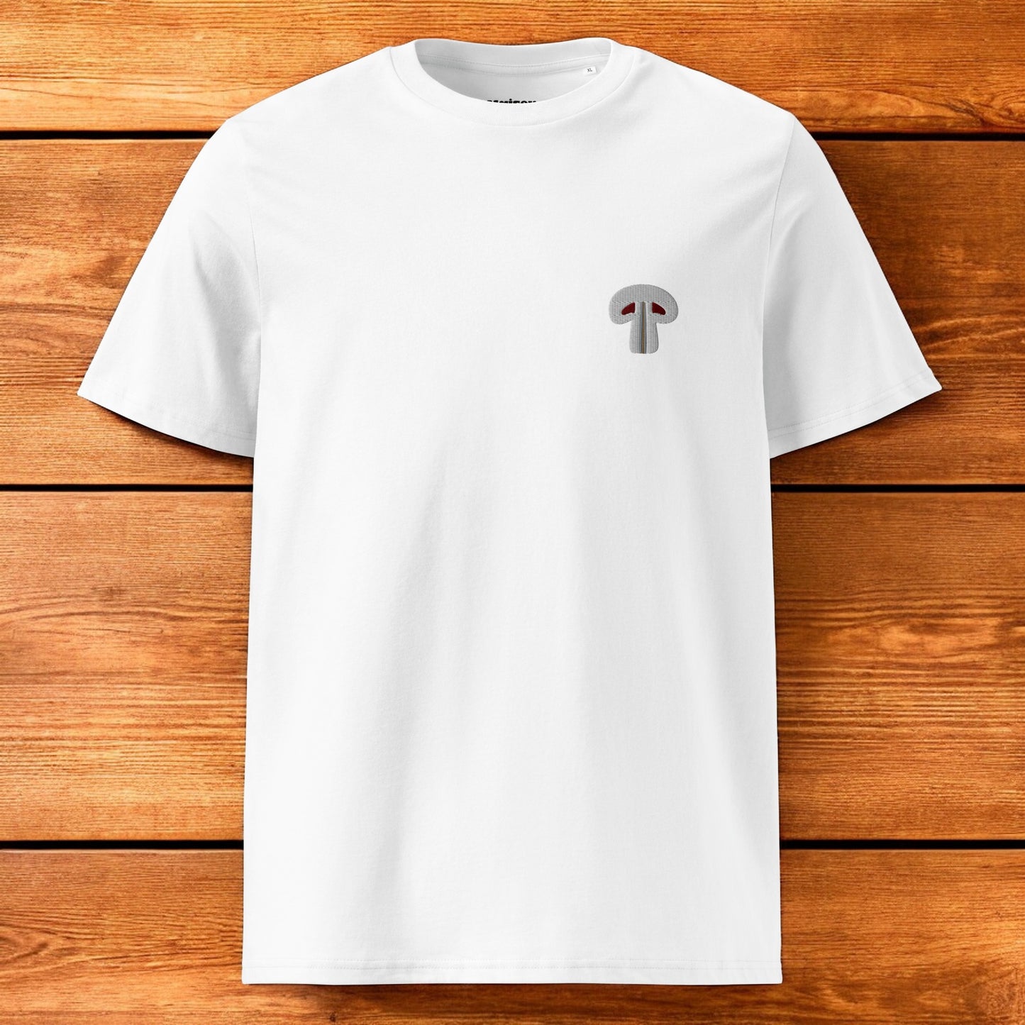 white t-shirt with paris mushroom and a wood background
