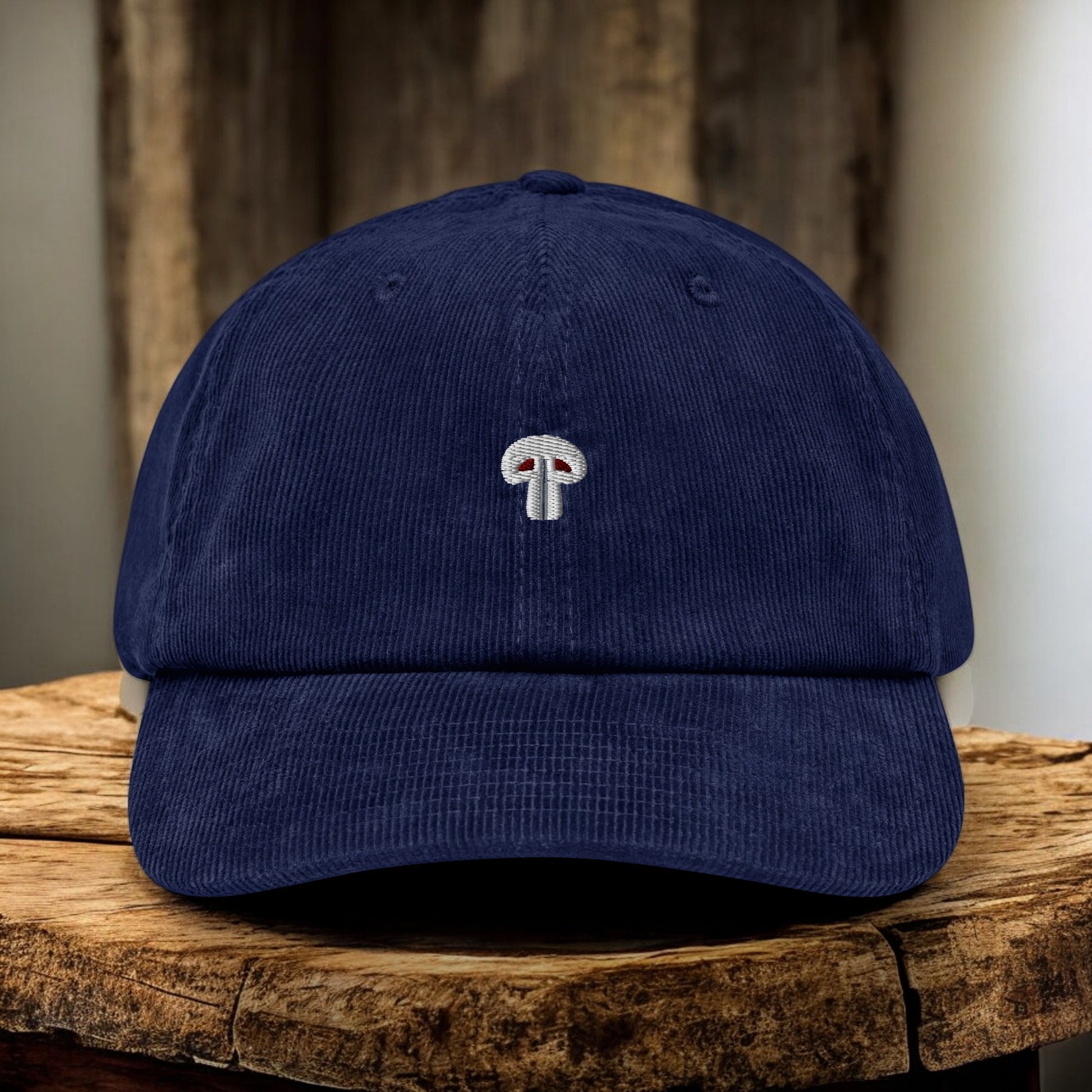 Blue Corduroy Paris Mushroom cap from the front on a wooden surface