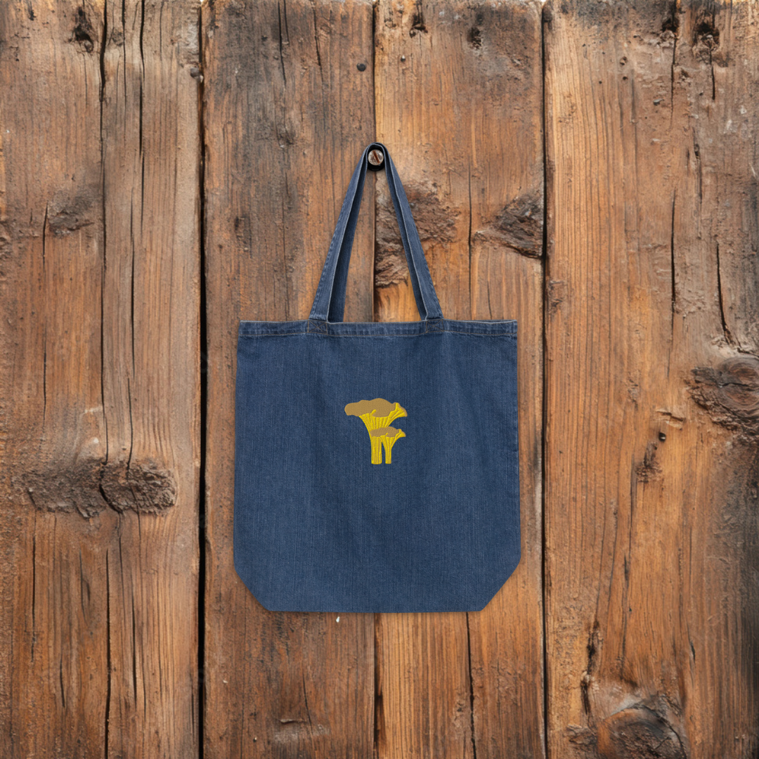 Denim tote bag chanterelle hanging from a wooden wall