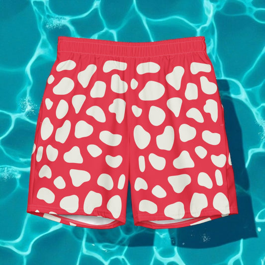 Red swim shorts with white pattern on a blue water background