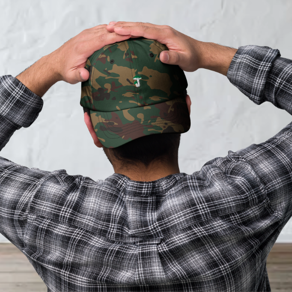 Front of the camouflage cap with a green russula, men wearing it