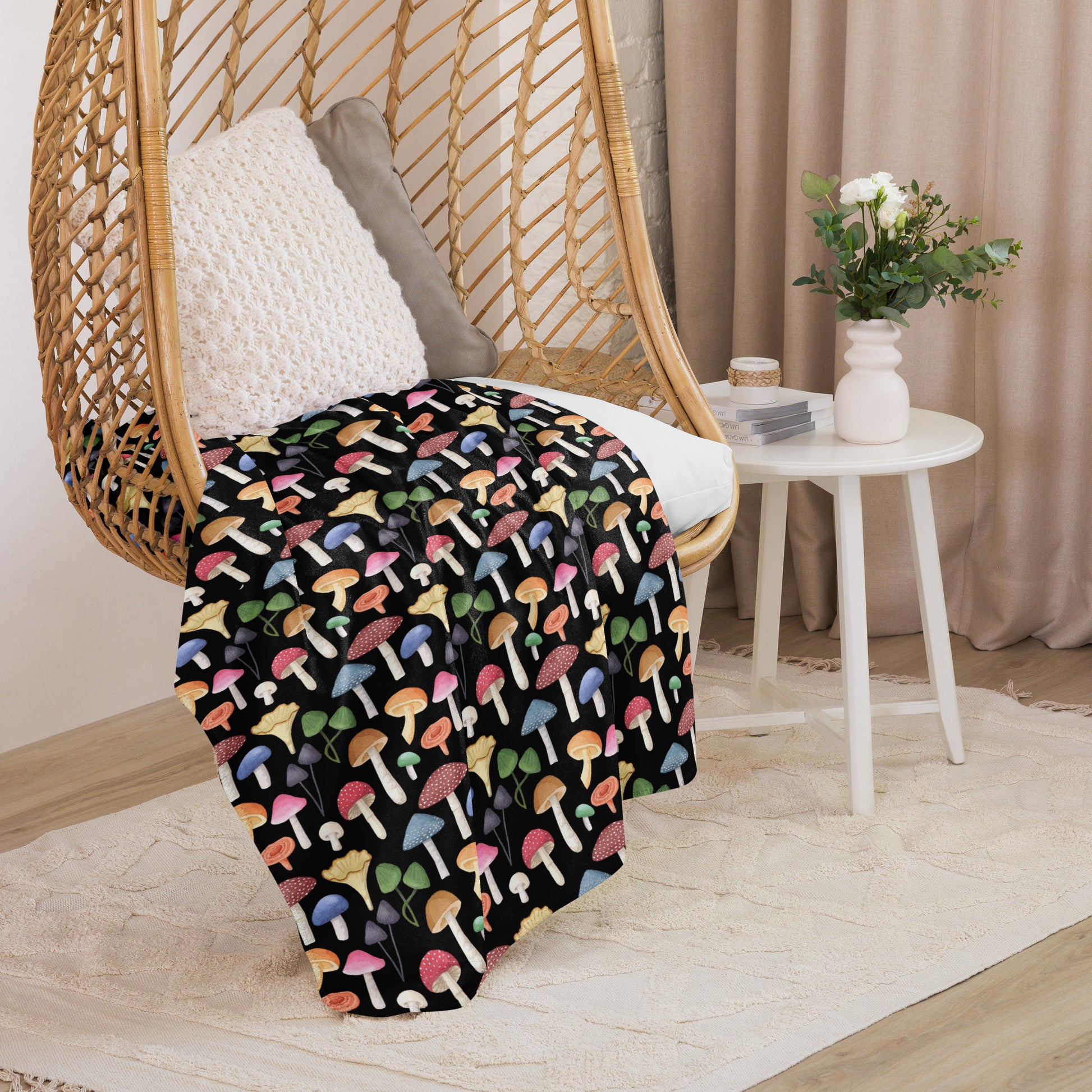 Mushroom Groves Blanket Black on a rocking chair