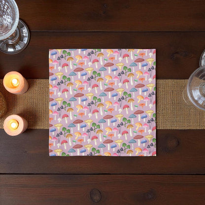 Colorful mushroom patterned paper on a wooden table with candles and glasses.