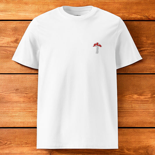 white t-shirt with fly agaric and a wood background