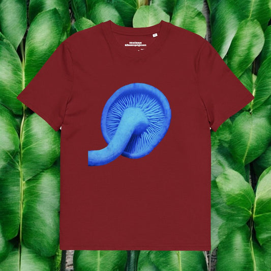 Blue Rhodocollybia on a red T-shirt on green leaves